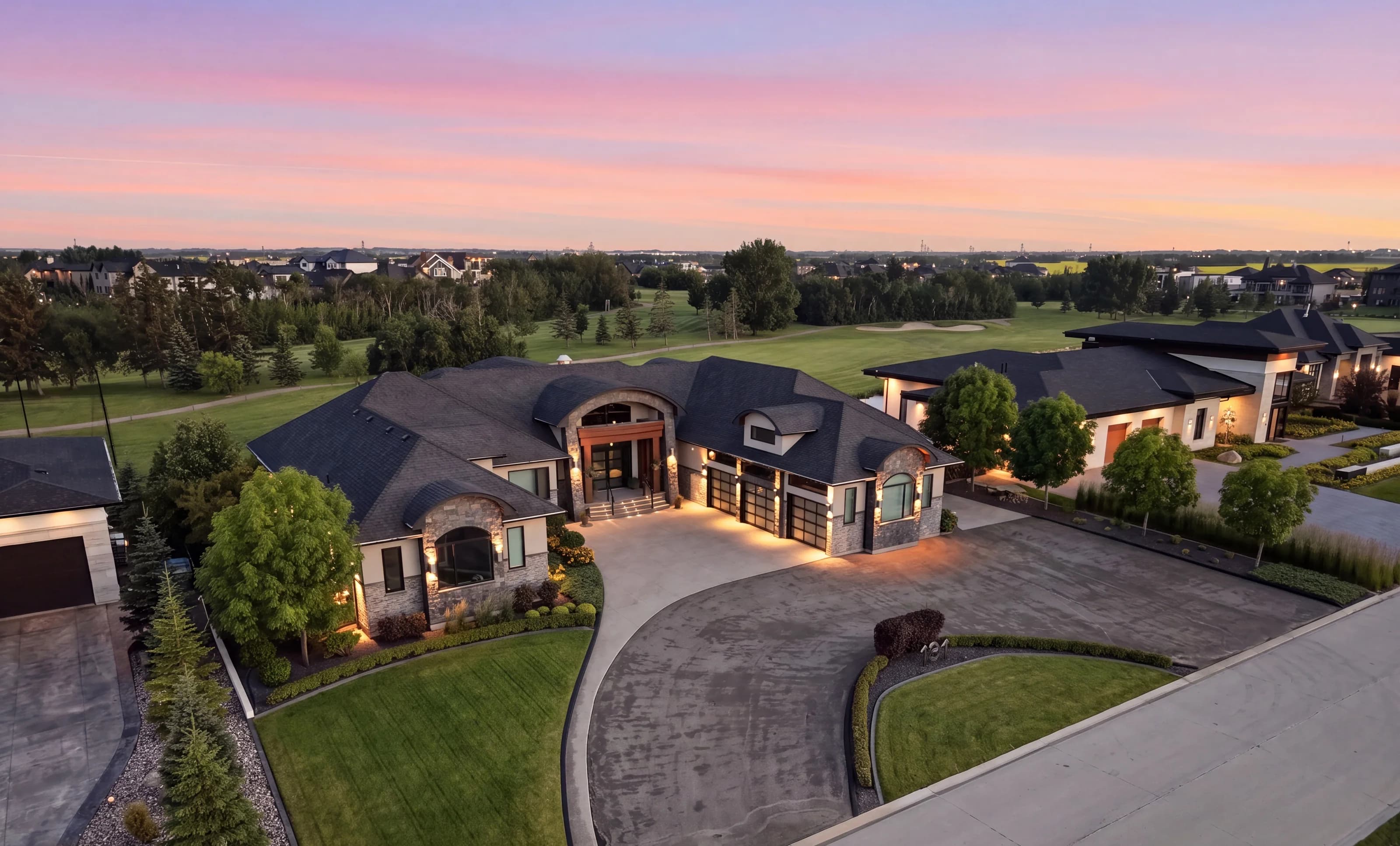 Aerial twilight photograph of a professionally lit luxury home