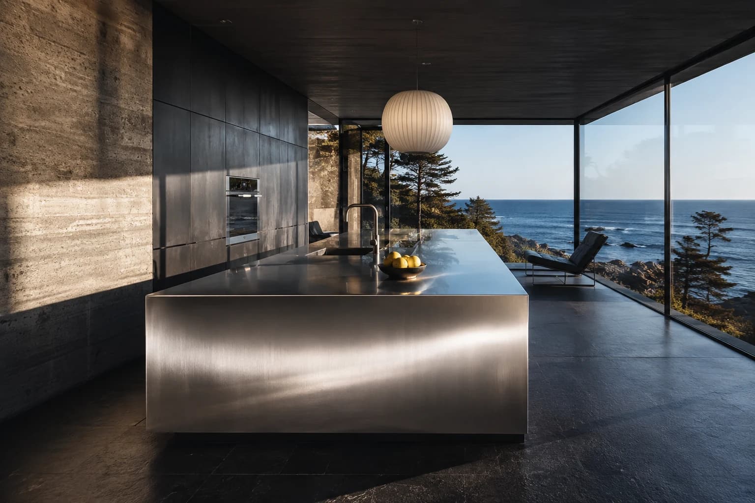 Illustrative coastal kitchen with natural stone, sculptural steel and warm wood surfaces